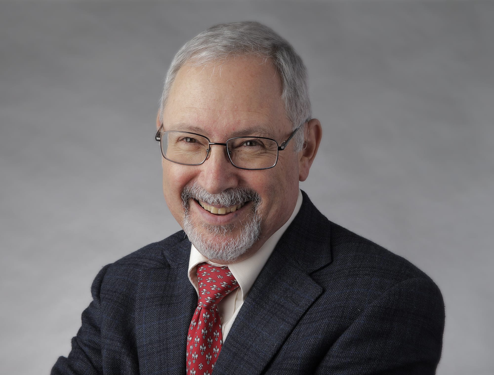 Headshot of a man in tie and jacket
