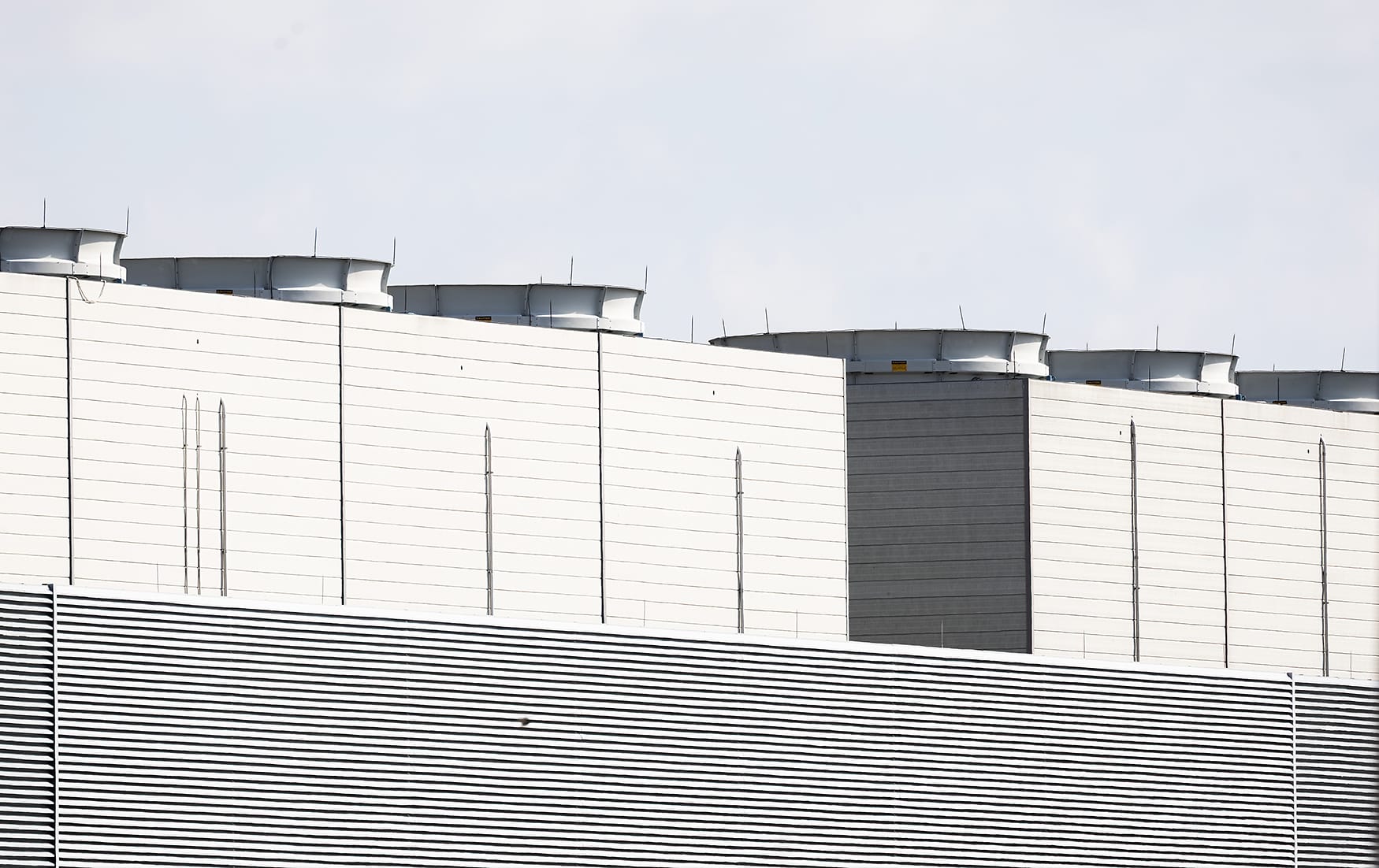 A line of large white industrial facilities fills the view.