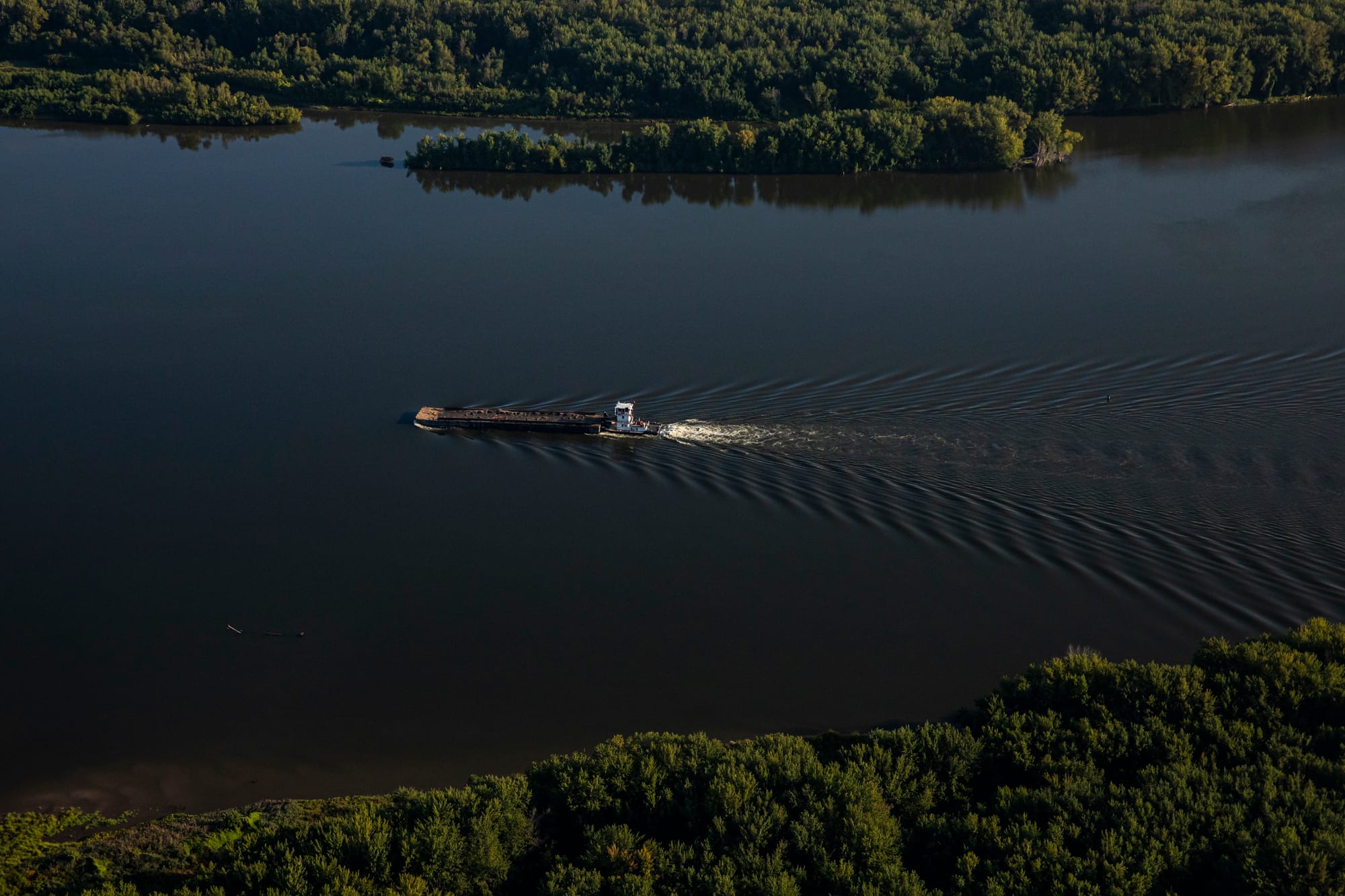A barge moves down the river