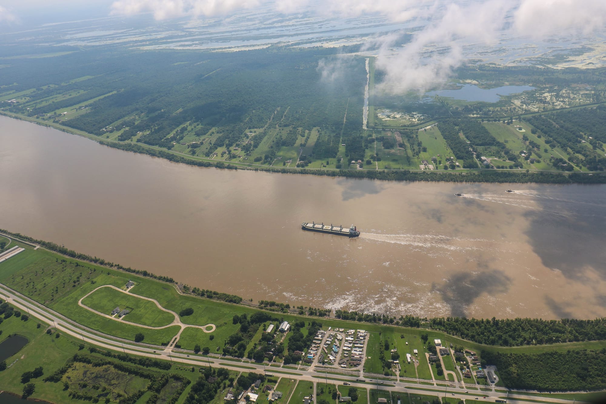 Aerial short of a barge traversing the Mississippi River in southern Louisiana.
