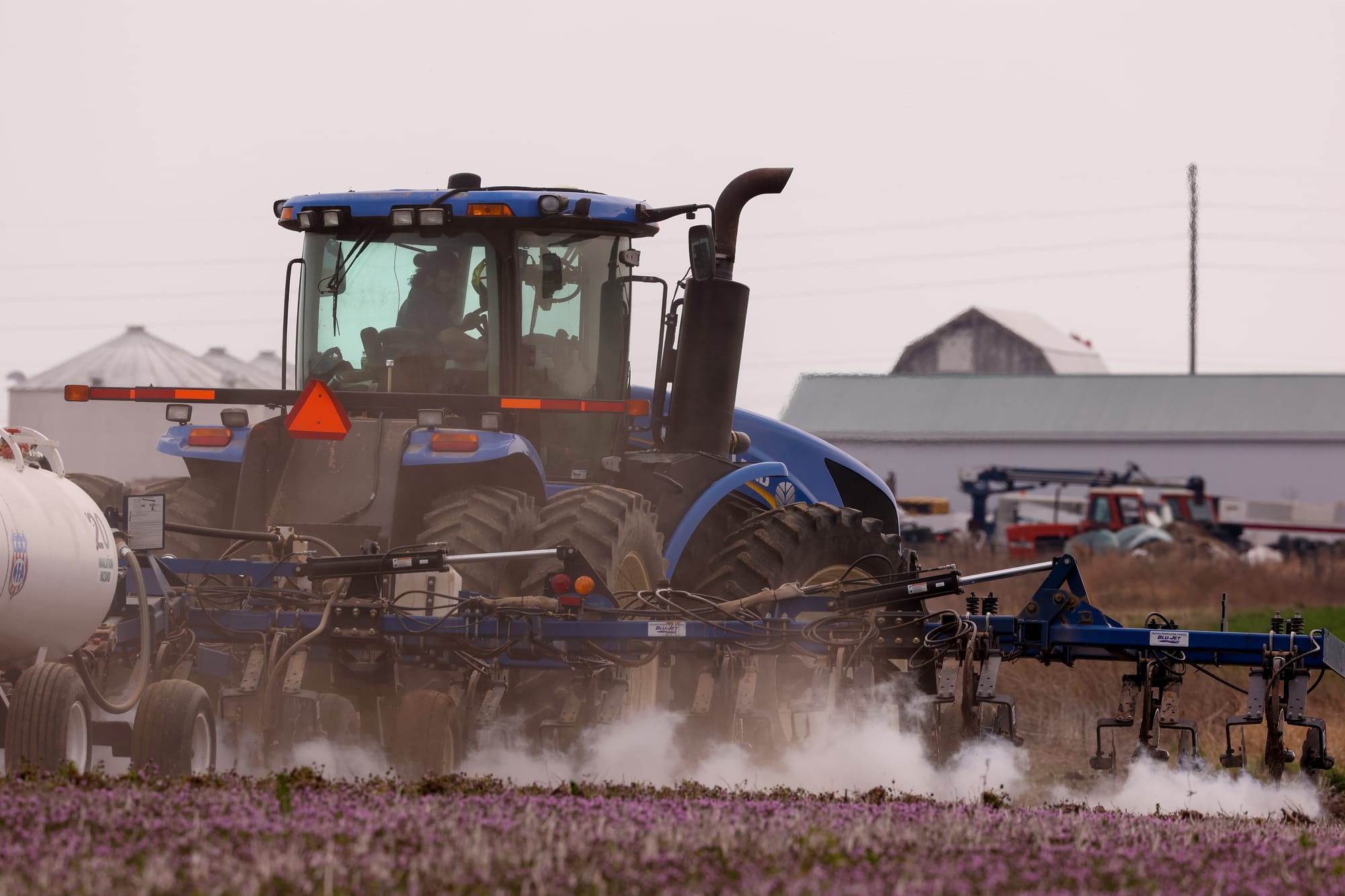 A tractor moves down a field
