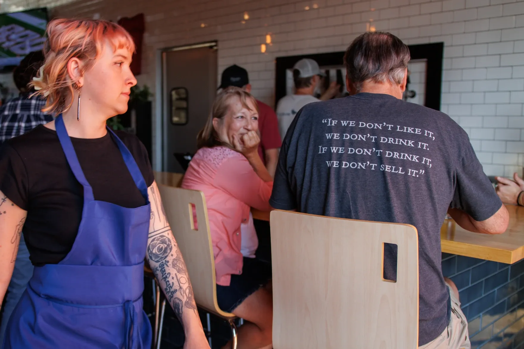 A couple sits together at a brewery event.
