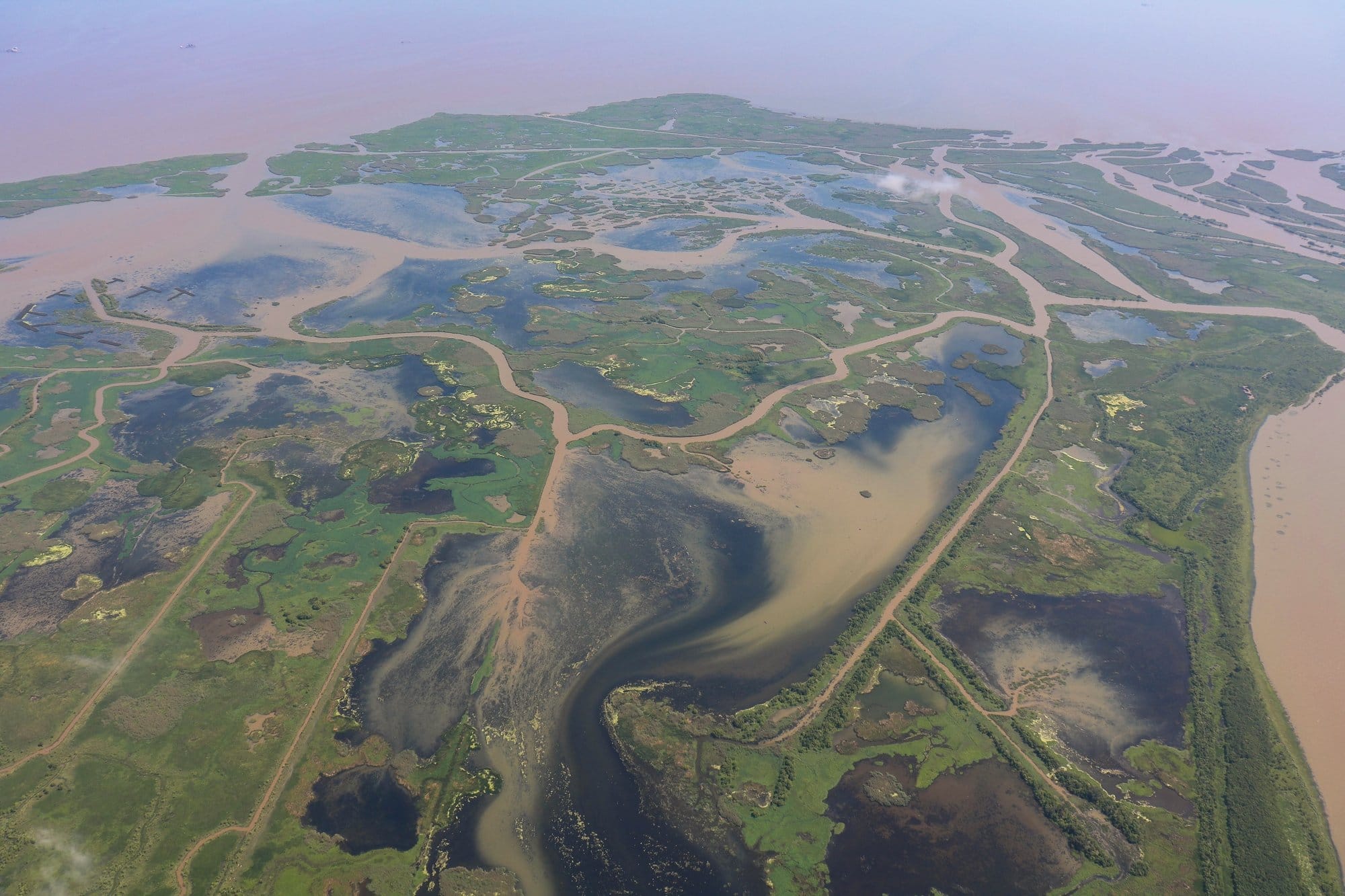 Aerial view of canals cutting through coastal wetlands in Plaquemines Parish, Louisiana, with areas of marsh eroded into open water.