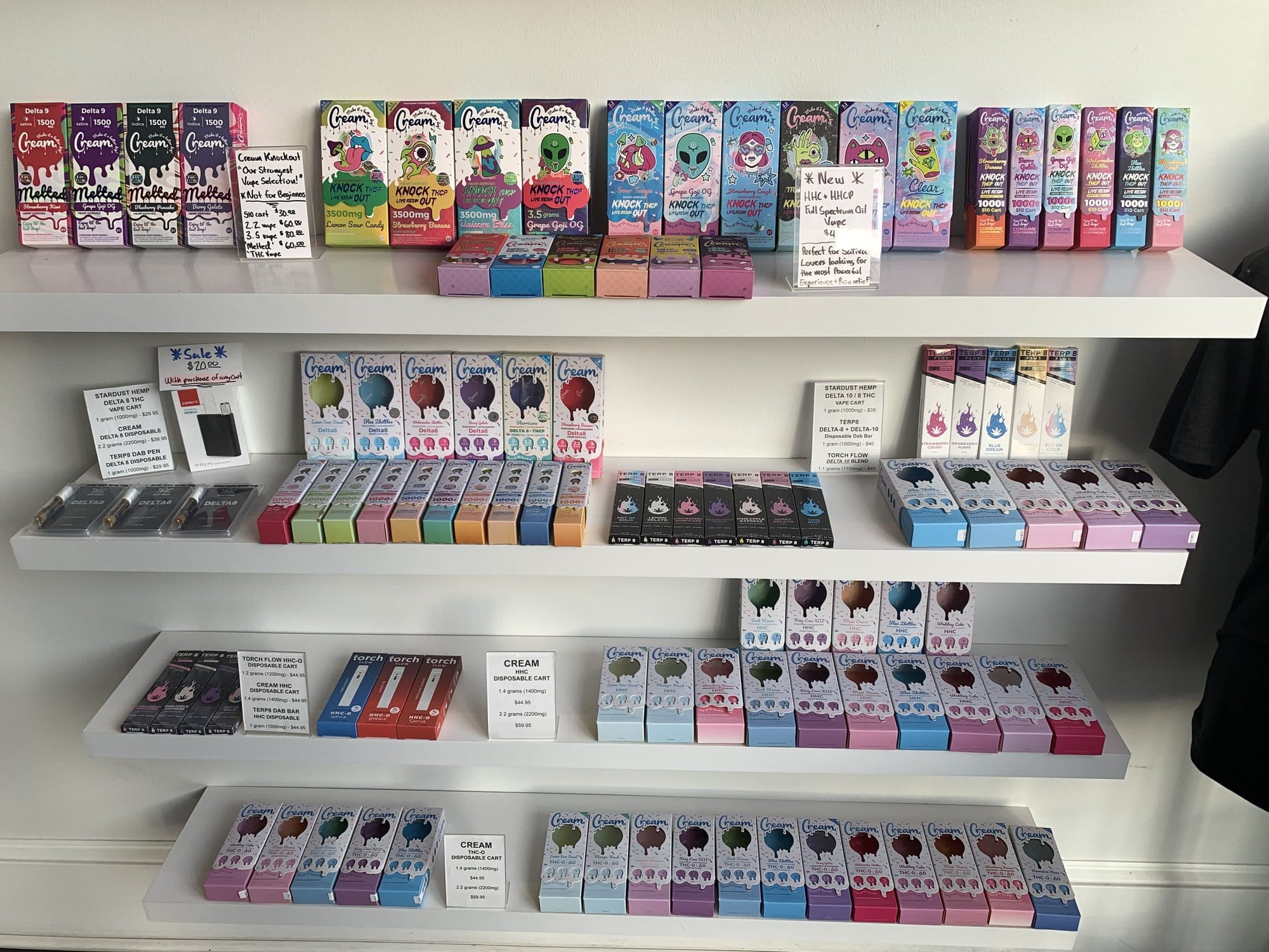 Shelves at a Kansas City hemp store display rows of colorful packaged CBD products for sale.