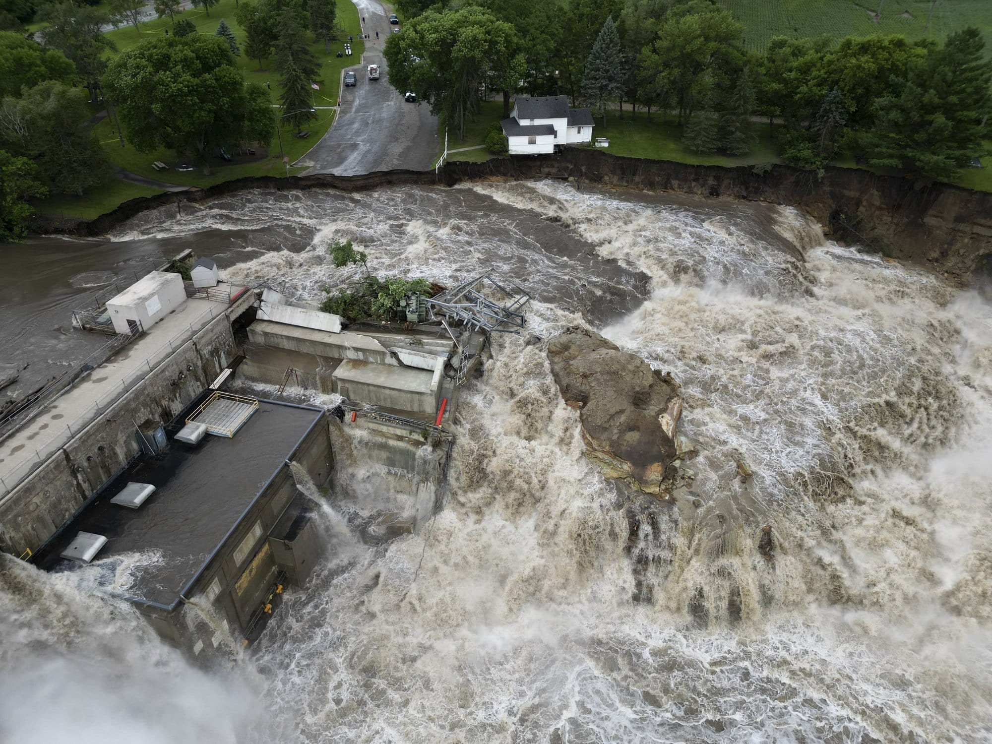 Aerial view of fast-moving floodwater eroding the ground around Rapidan Dam.