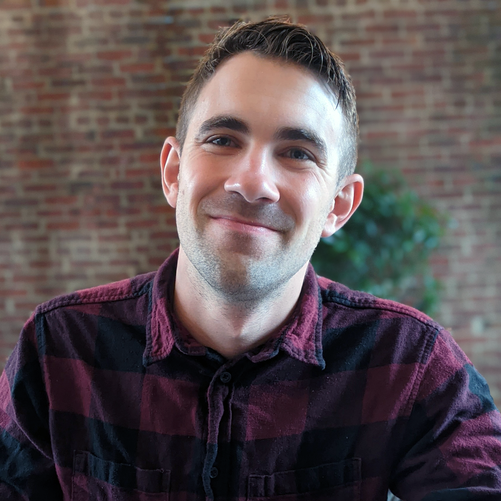 headshot of a smiling man