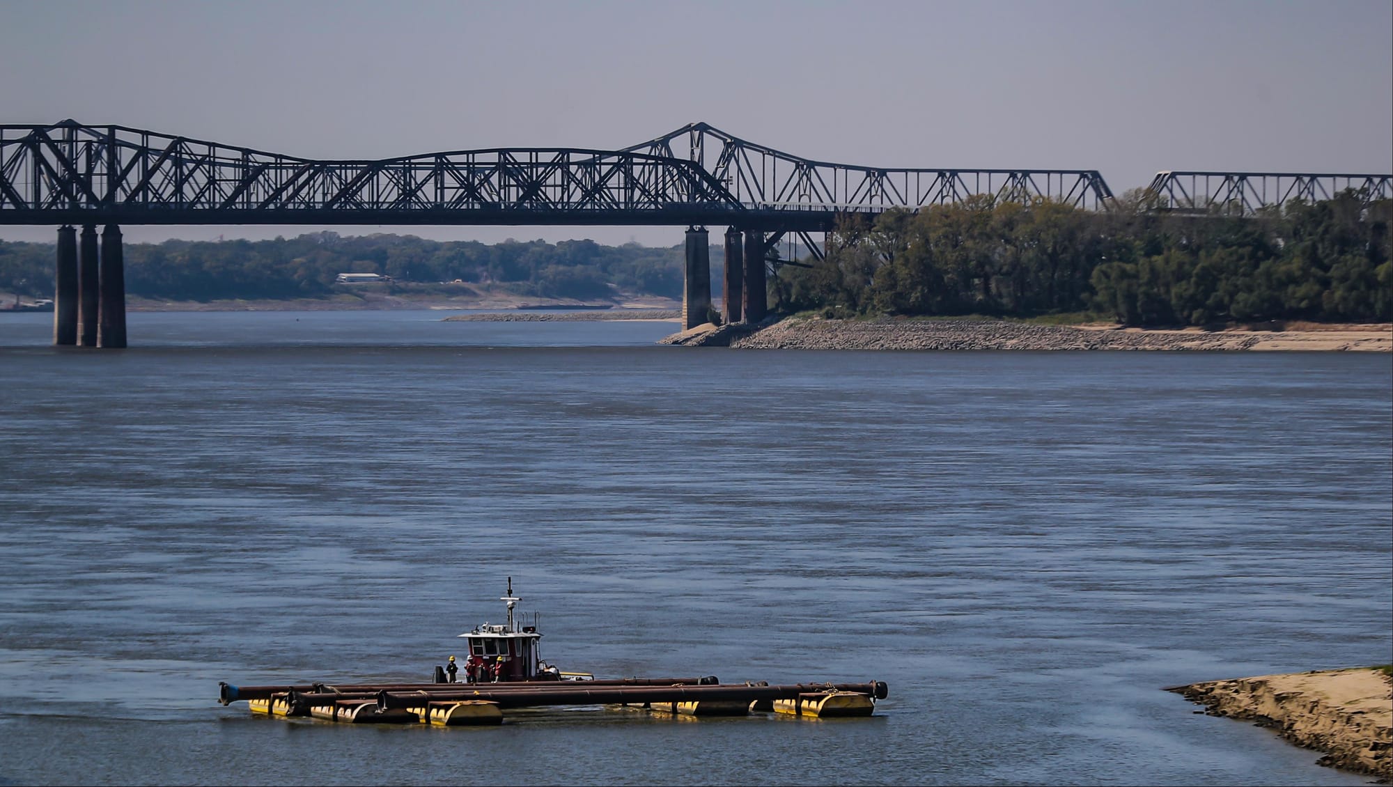 Crews move pipes across the Wolf River Harbor in Downtown Memphis Oct. 6, 2022.