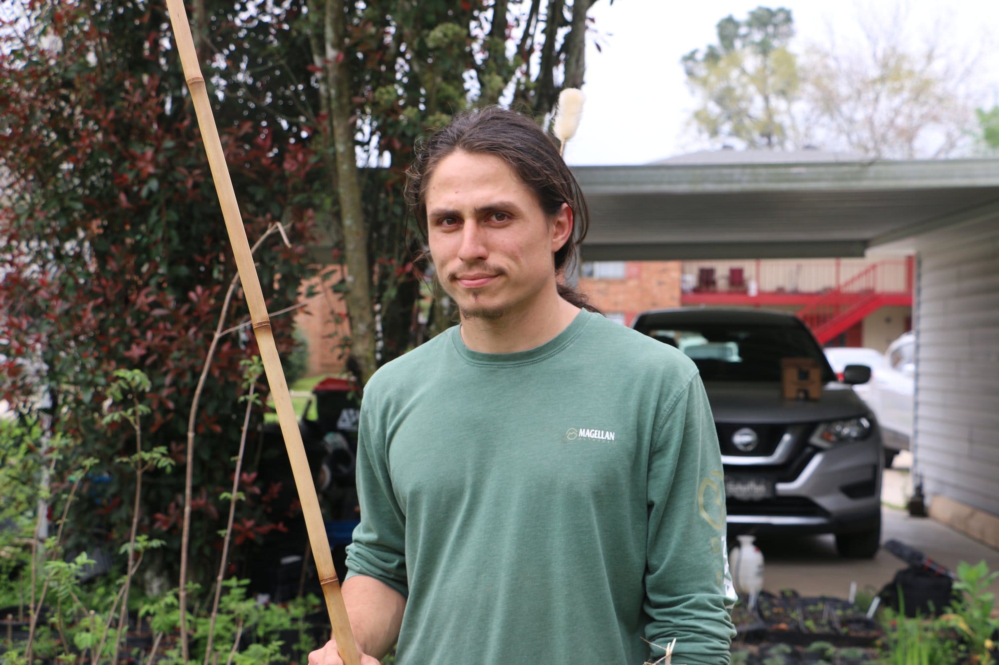 Louisiana farmer Bruno Sagrera shows off a blow gun he made out of river cane.