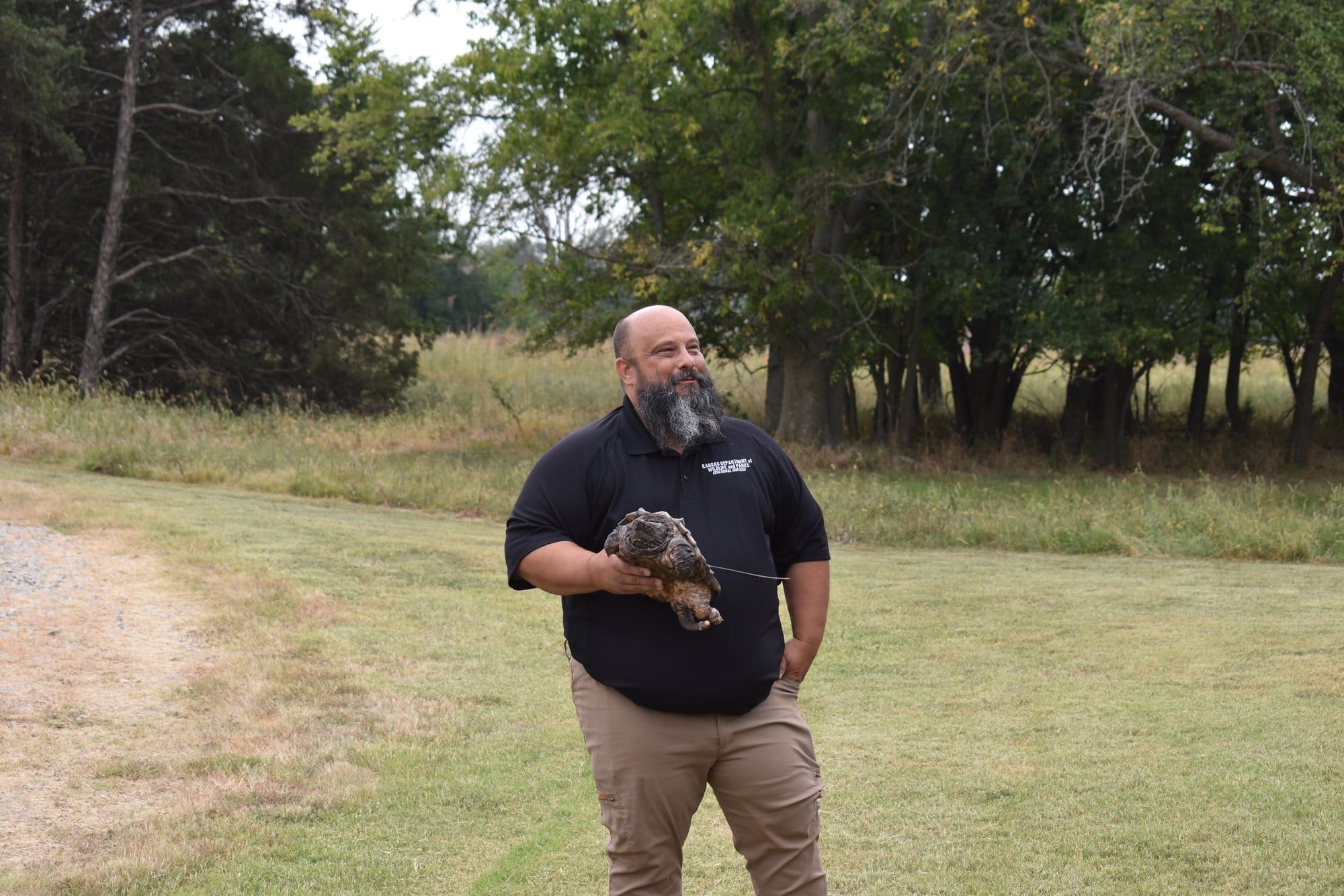 Daren Riedle, wildlife diversity coordinator for the Kansas Department of Wildlife & Parks, holds an alligator snapping turtle.