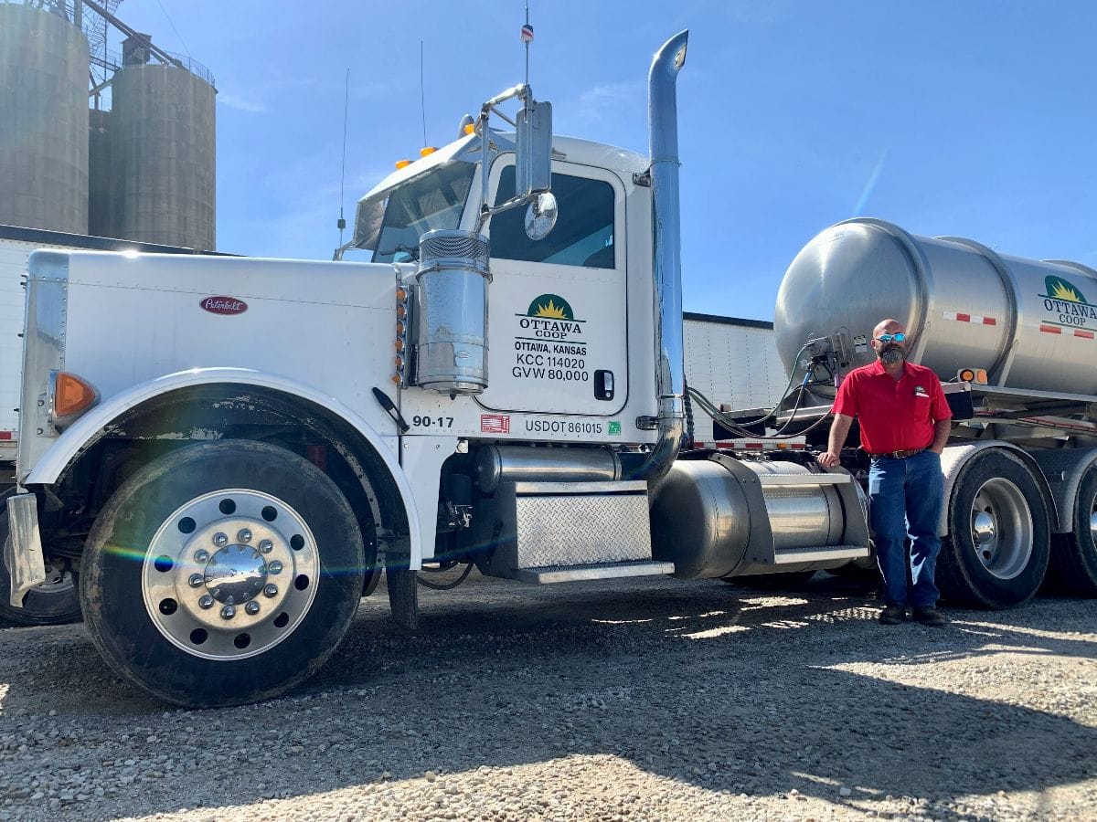A man stands by his truck