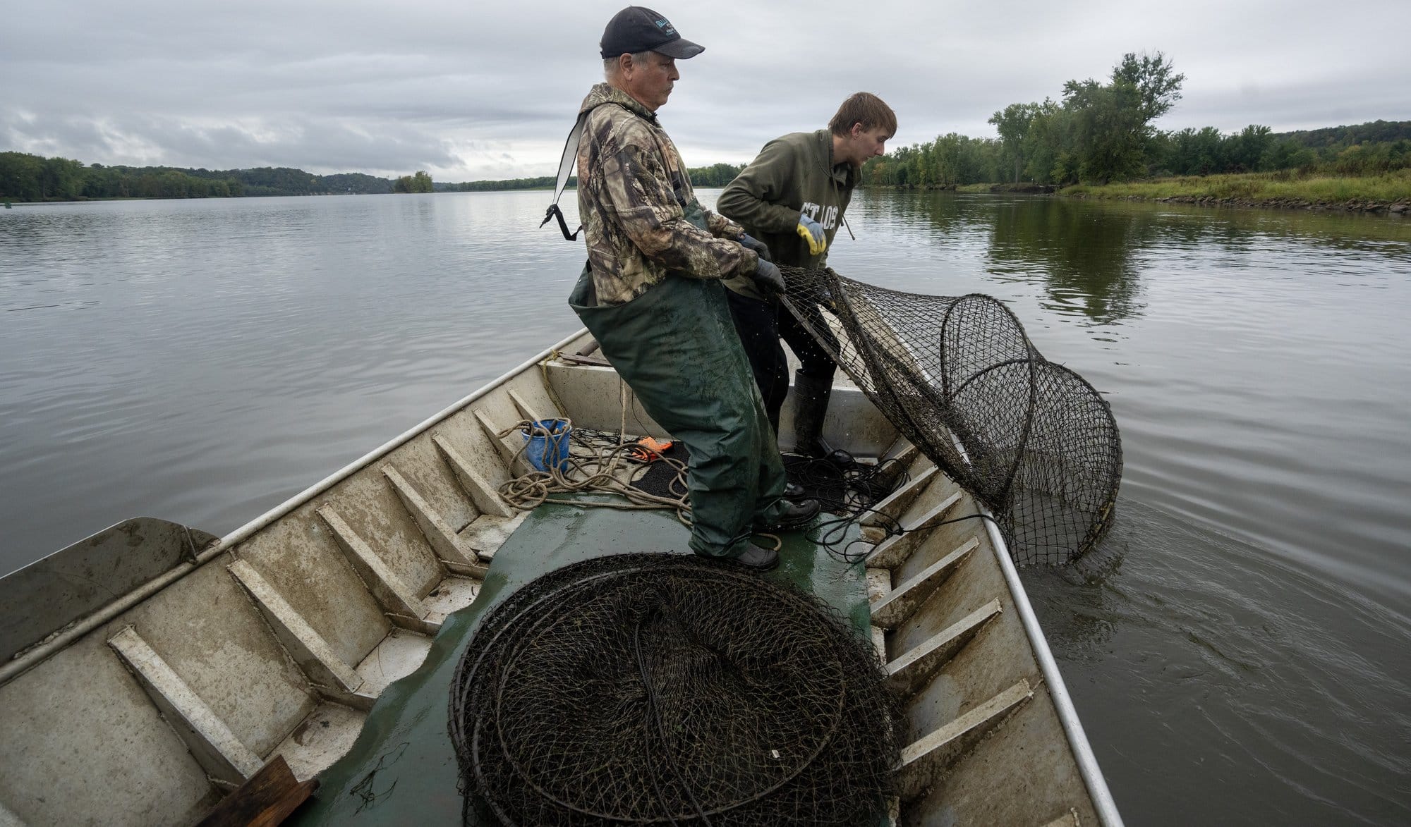 Mike Valley, left, and his grandson, Bryce Priebe, haul in a net Sept.