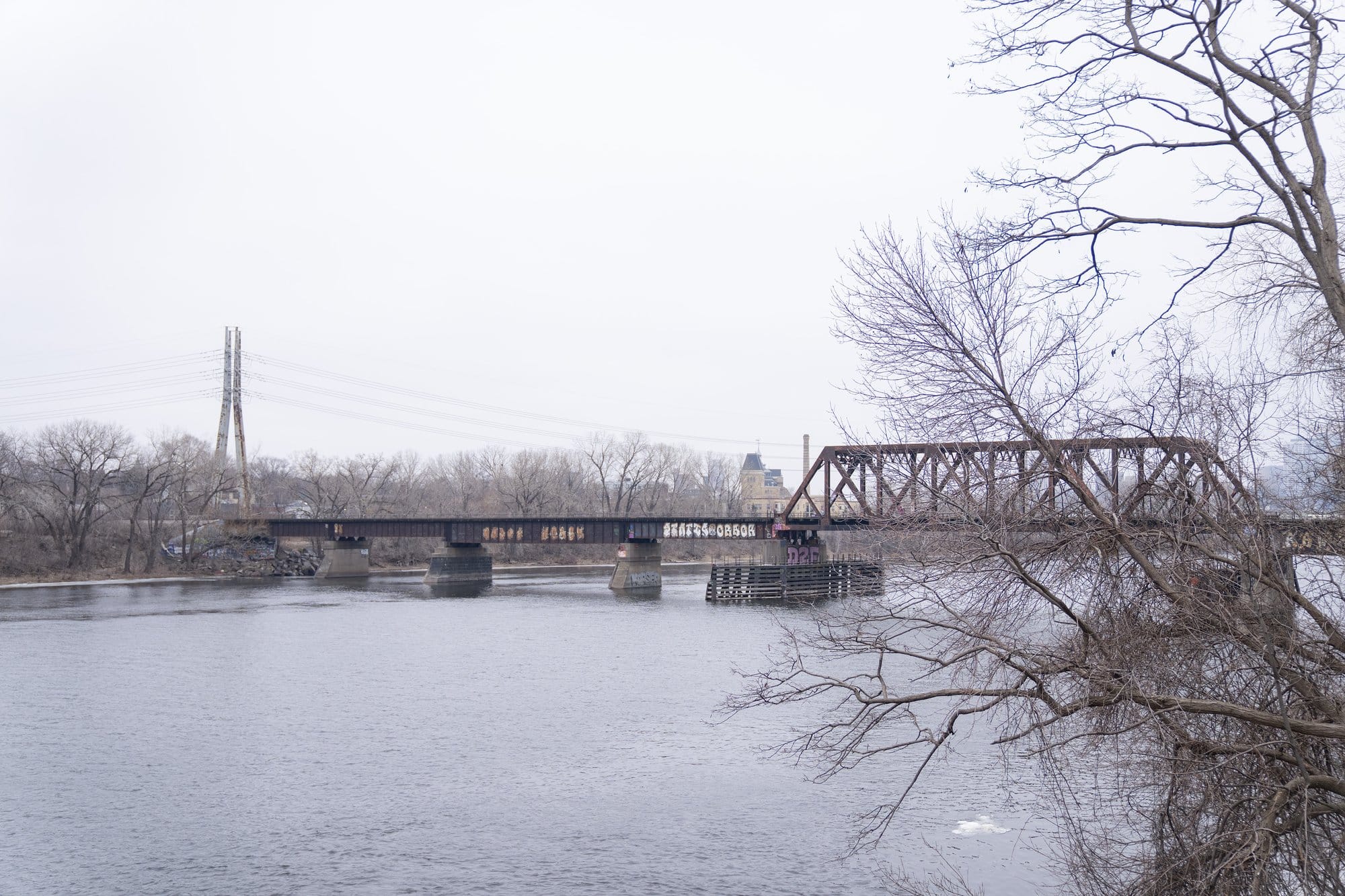 View of the river with a bridge over it on a winter day