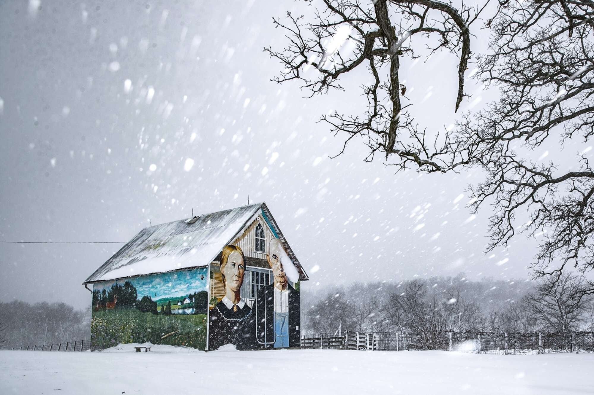 Snow fell over the American Gothic Barn on Friday, Jan.