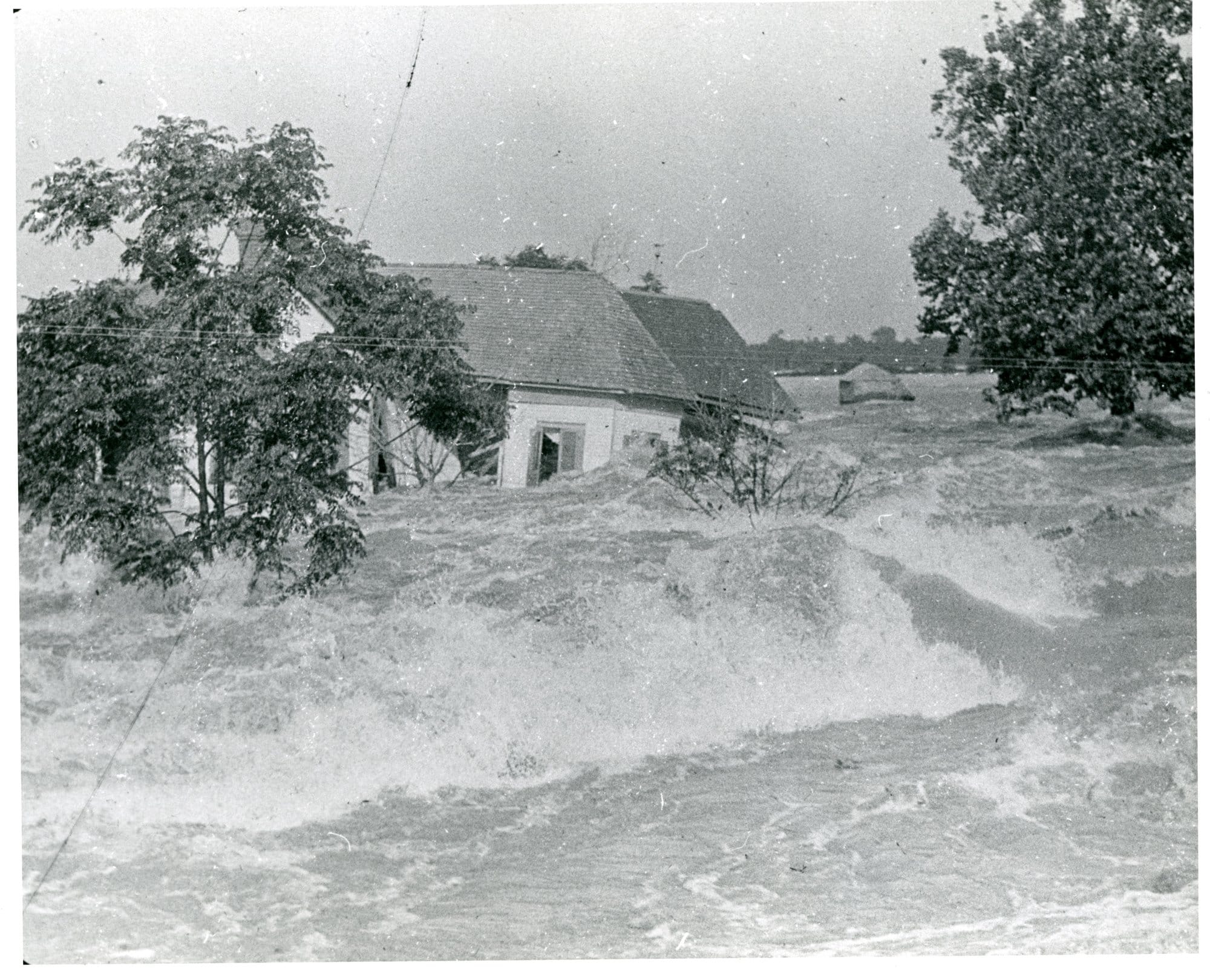 A house is swept away by torrential floodwaters in the Great Mississippi River Flood of 1927.