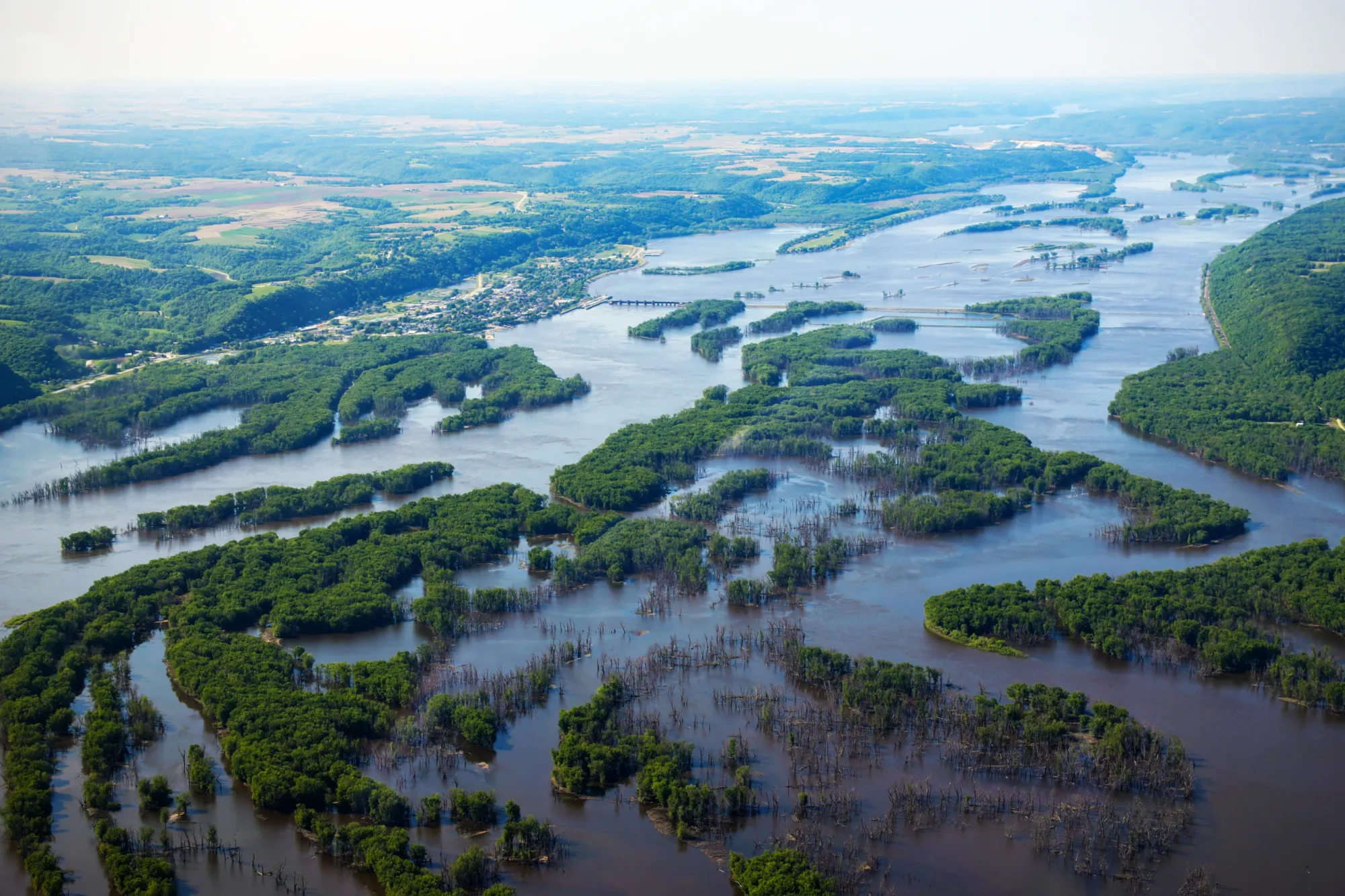 Aerial view of high water along the Mississippi River near Guttenberg, Iowa, with water surrounding numerous tree-covered islands and partially submerged vegetation.