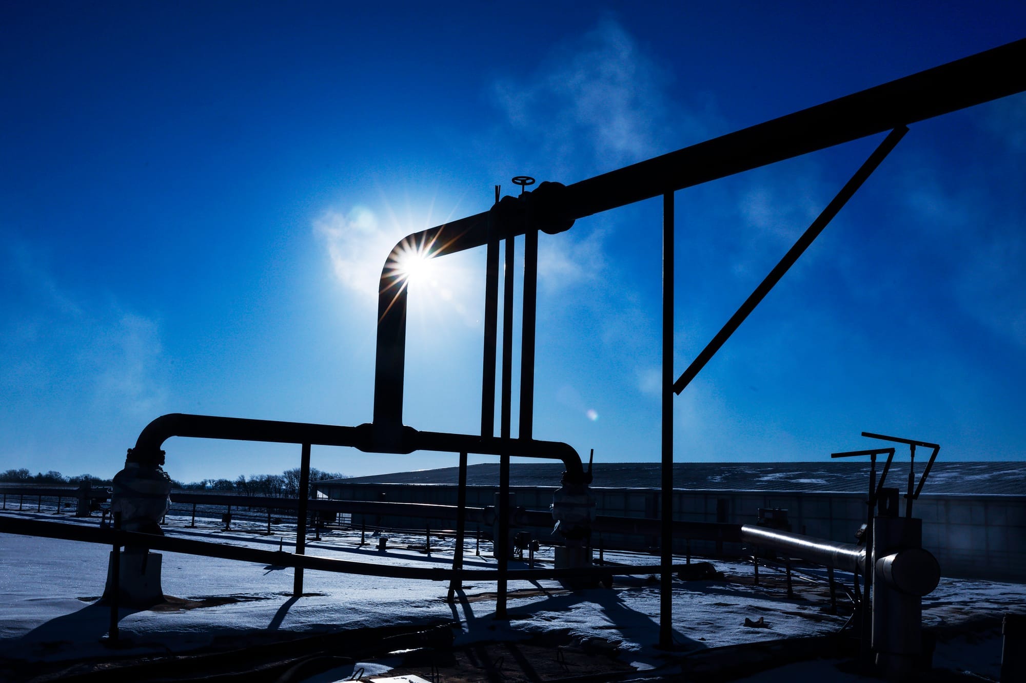 Pipes carry methane from an anaerobic digester at Amana Society Farms in Amana, Iowa, with snow covering the ground.