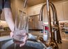 Tyler Frye fills a glass with water from a faucet that dispenses water processed with reverse osmosis Monday, February 5,