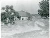 An archival photo of a flooded house