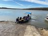 A boat launches into a river from a dock