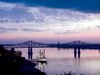A casino boat floats near a bridge over the Mississippi River