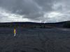 a reporter takes a photo in a coal waste field