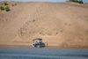A boat is docked on a huge mountain of sand 
