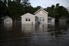 A home is partially submerged in floodwater.