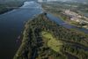 Aerial view of the mississippi river diverging and a town on the land below