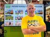 A man stands in front of a screen that says "picture yourself in agriculture" with a Choose Iowa logo and photos of families at the Iowa State Fair
