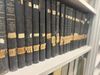 Historical weather records are stacked on a bookshelf. The labels indicate that the volumes date back to the early 1900s.