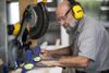 A man cuts wood in a workshop 