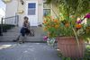 Laurie Thomas sits on the front step of her mother’s home in Freeport, Illinois.