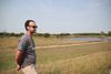 A man stands beside a pond on farmland in Atchison County, Missouri, where a levee was breached during the 2019 Missouri River flood.