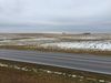Light snow covers Midwestern farmland.