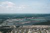 Aerial view of a river town with islands. An industrial plant sits close to the edge of the water