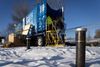 Workers enter a trailer containing technology being tested to destroy PFAS chemicals removed from groundwater in Minnesota.