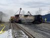 Workers and heavy equipment surround derailed and damaged tanker cars along railroad tracks in East Palestine, Ohio.