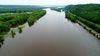 Aerial view of river with green trees partially submerged
