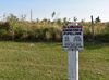 A warning sign marks an underground ammonia pipeline in a grassy area in Florida’s Bone Valley, a major fertilizer-producing region.