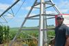 A farmer stands outside his chicken barns 