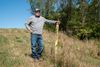A farmer stands next to the yellow tag marking where a natural gas pipeline traverses underneath his Scott County, Illinois farm.