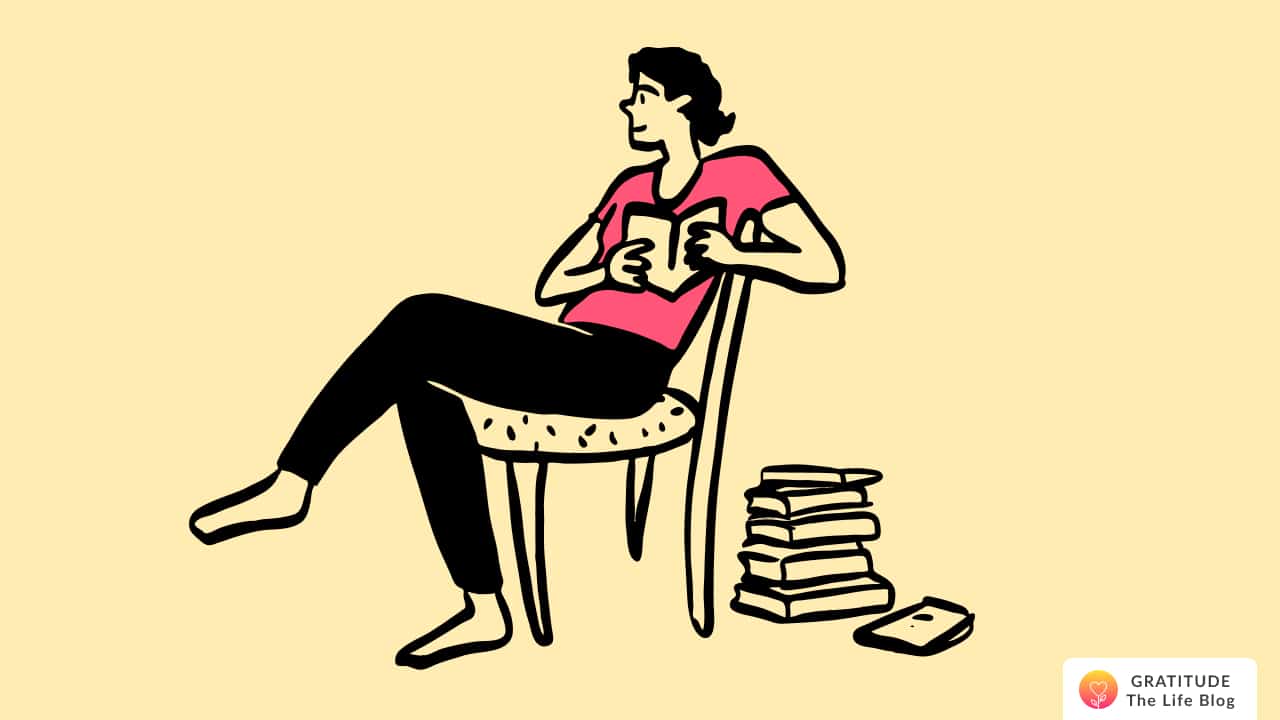A man sitting on a chair, reading his journal to self-reflect