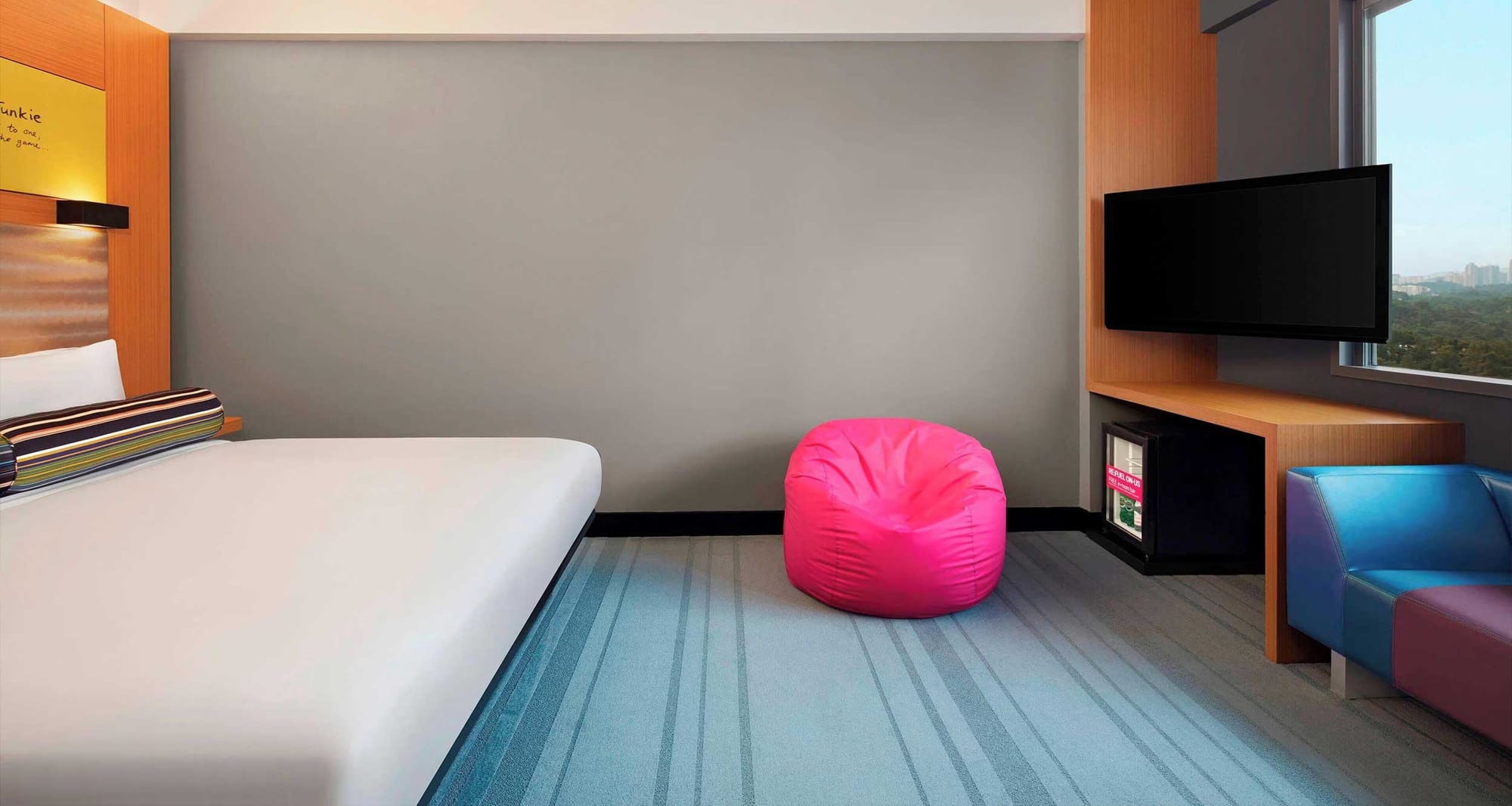 Spacious hotel room with bed and sofa in Kuala Lumpur.