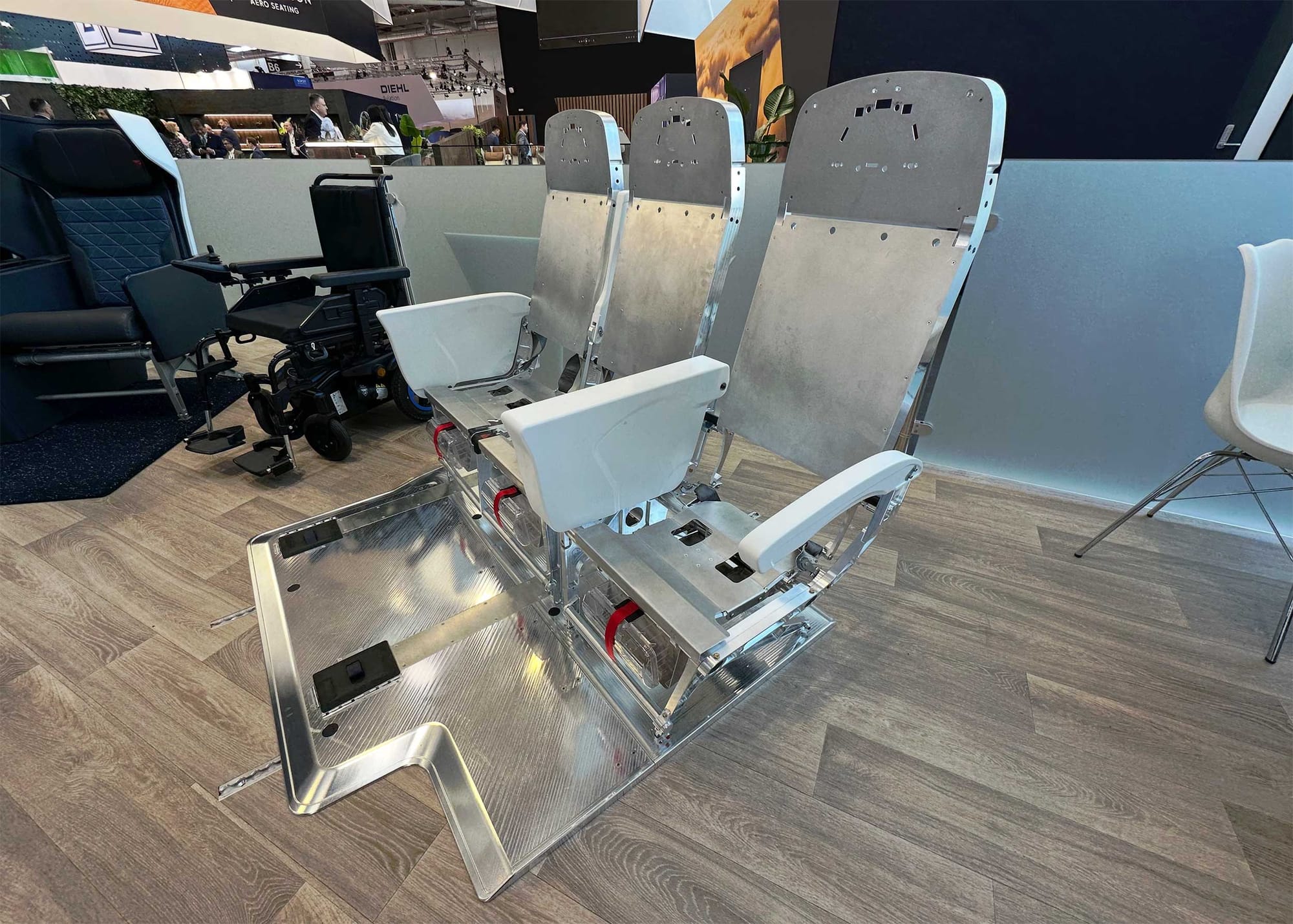 Engineering prototype of triple seat system for wheelchair securement, stripped down to show the visible metal components.