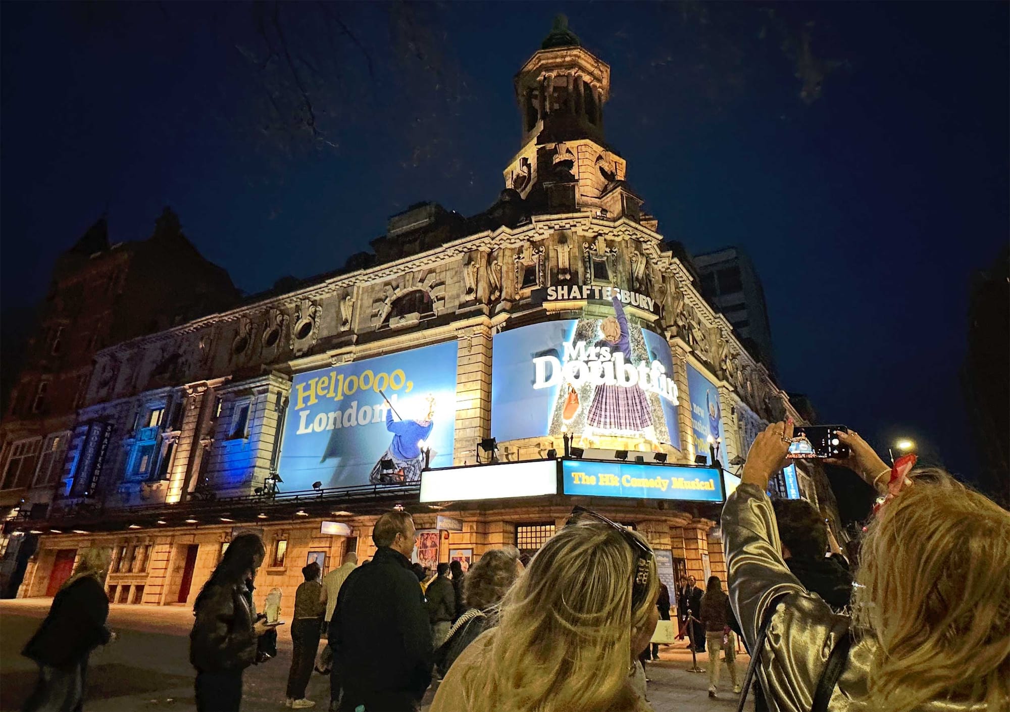 Mrs. Doubtfire signage outside of the Shaftesbury Theatre at night.