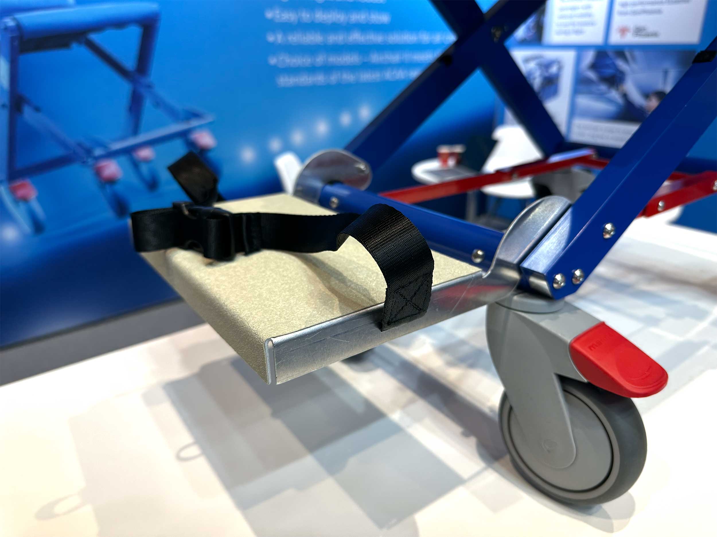 Footplate on front of aisle chair with straps to cover feet.