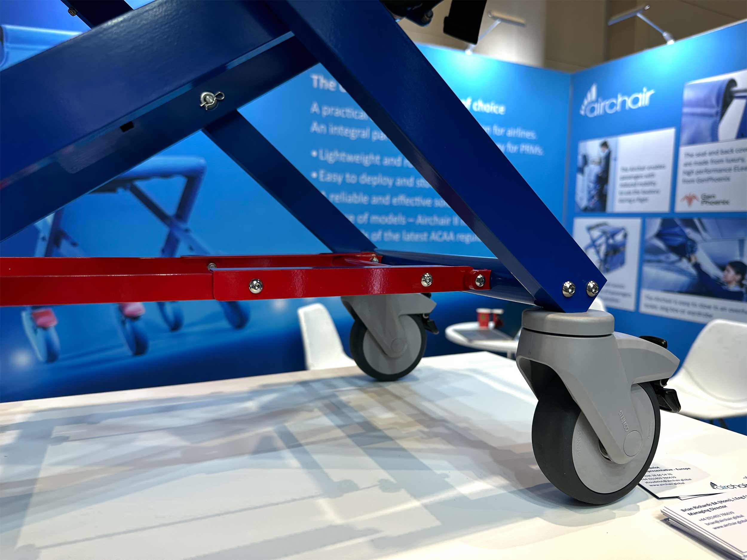 Safety stay bars under aisle chair and wheel locking mechanism.