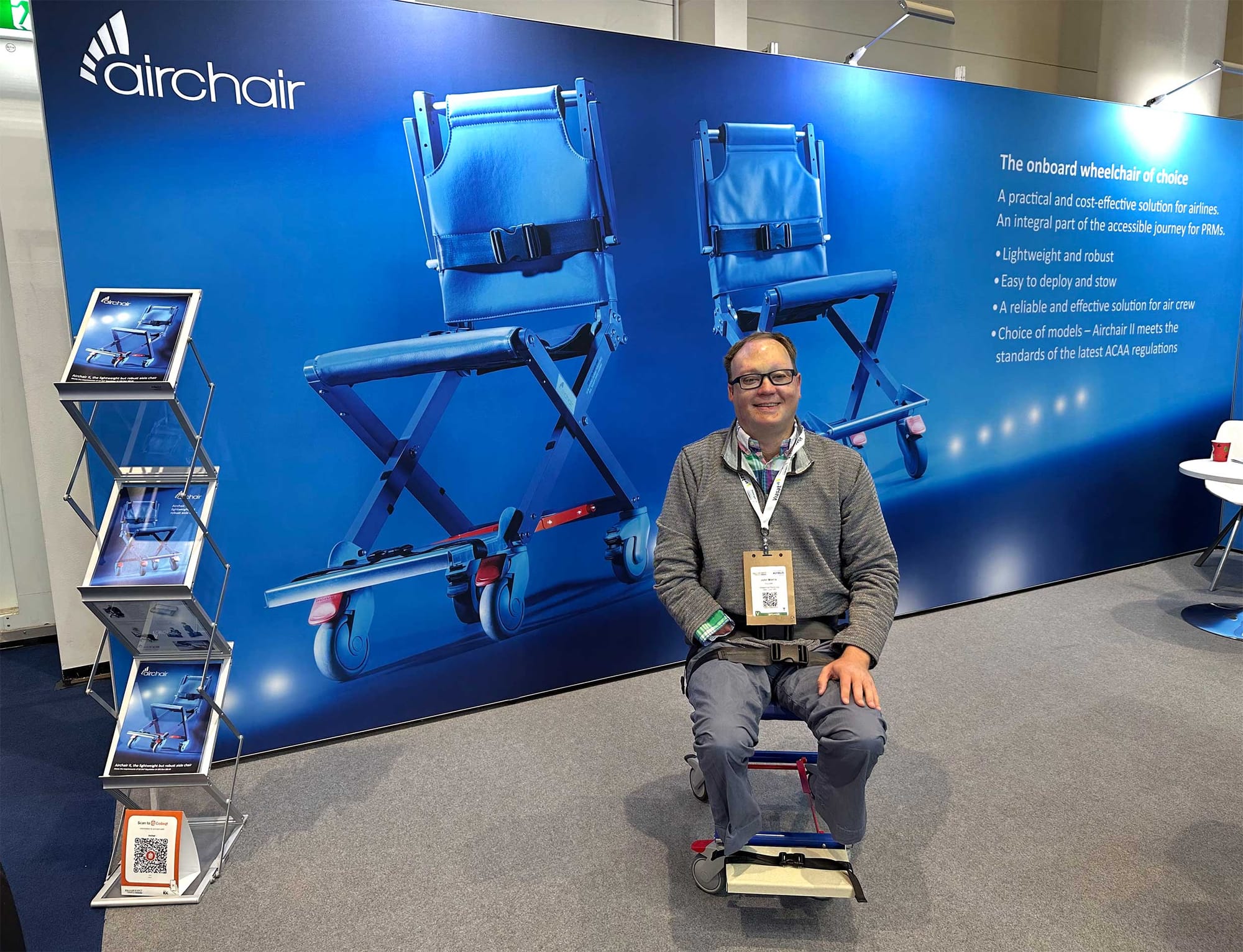 John seated on aisle chair.