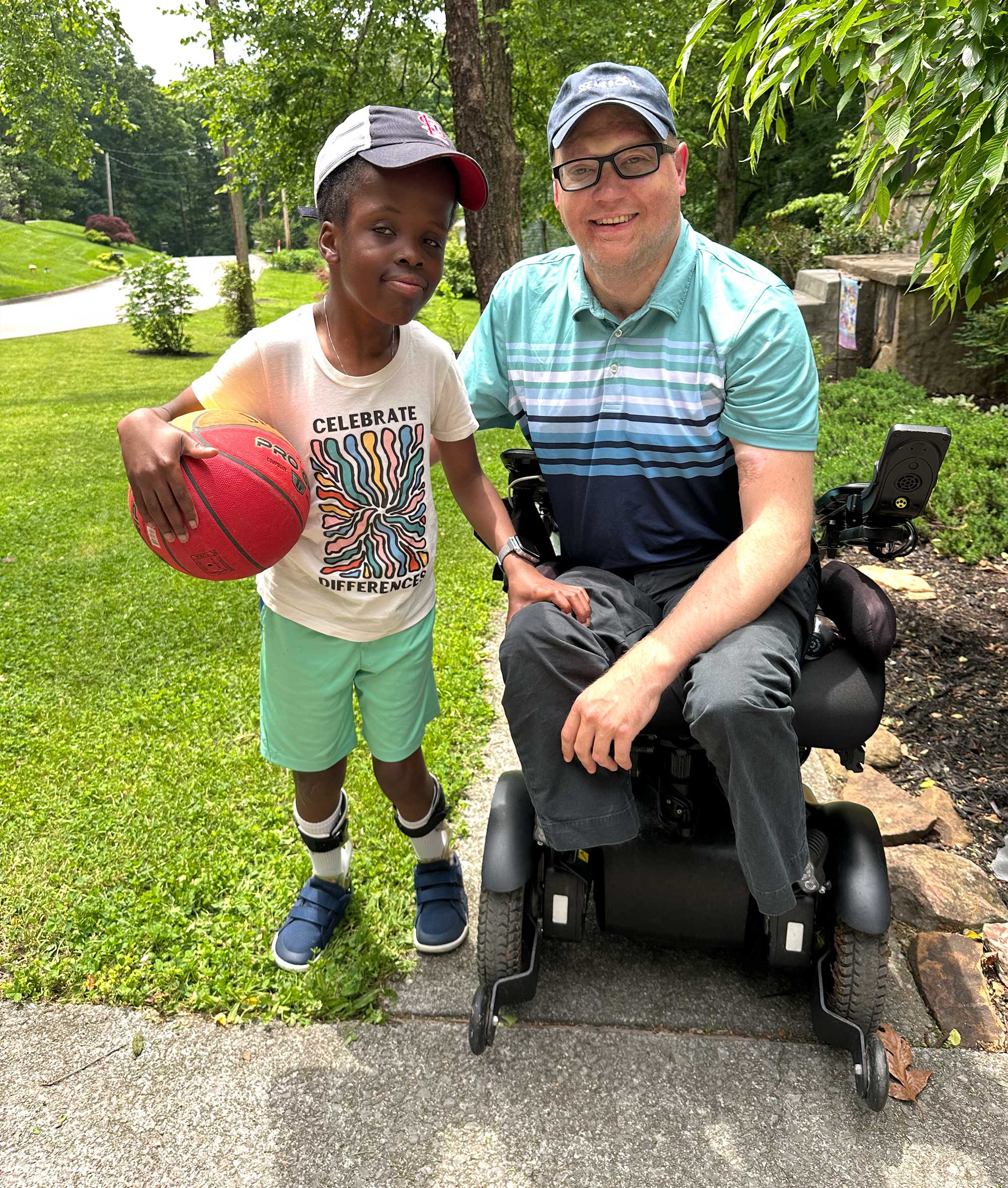 John with Robert who is holding a basketball.