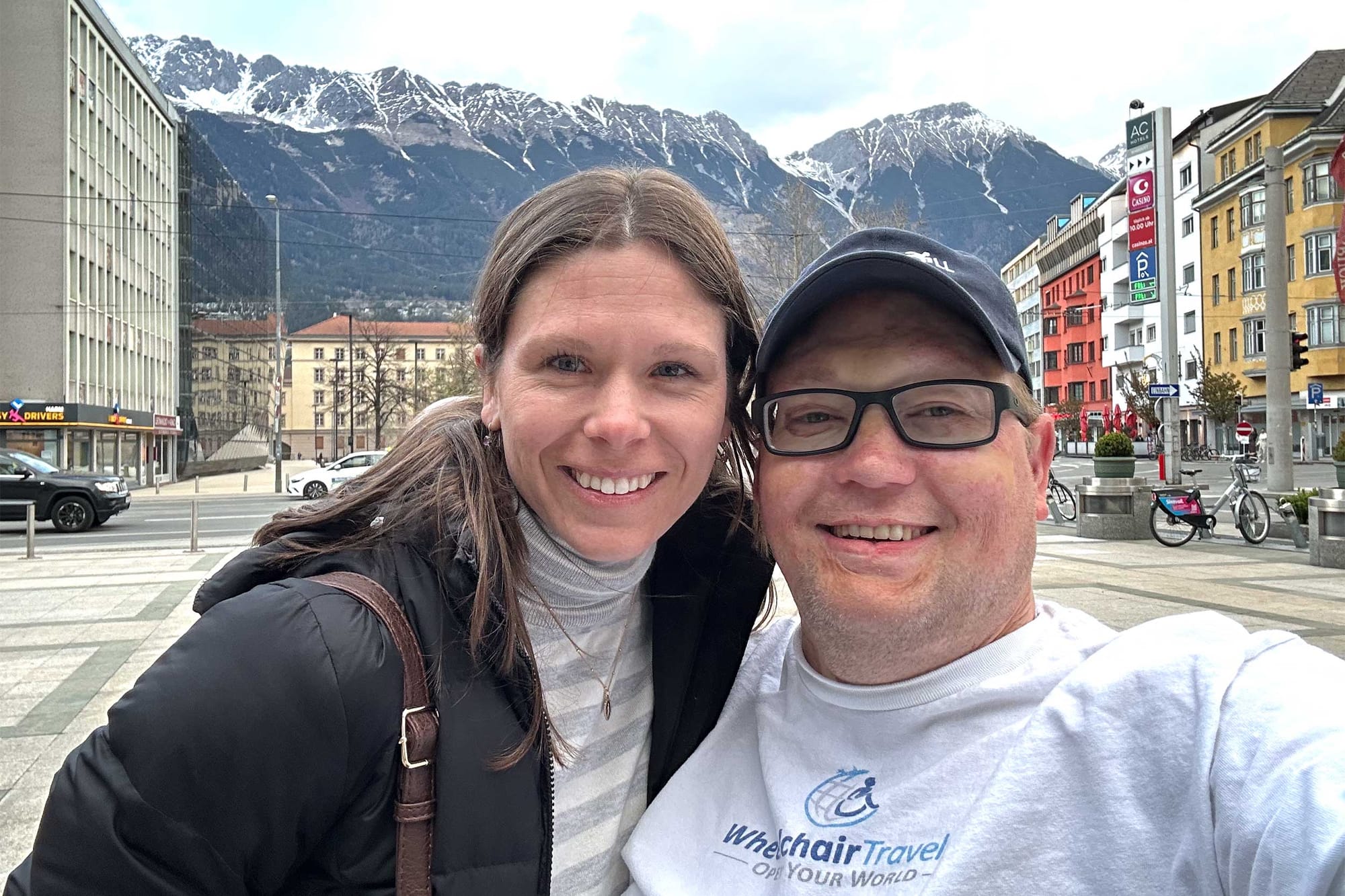 Selfie of Stevie and John wearing a Wheelchair Travel t-shirt in Austria.